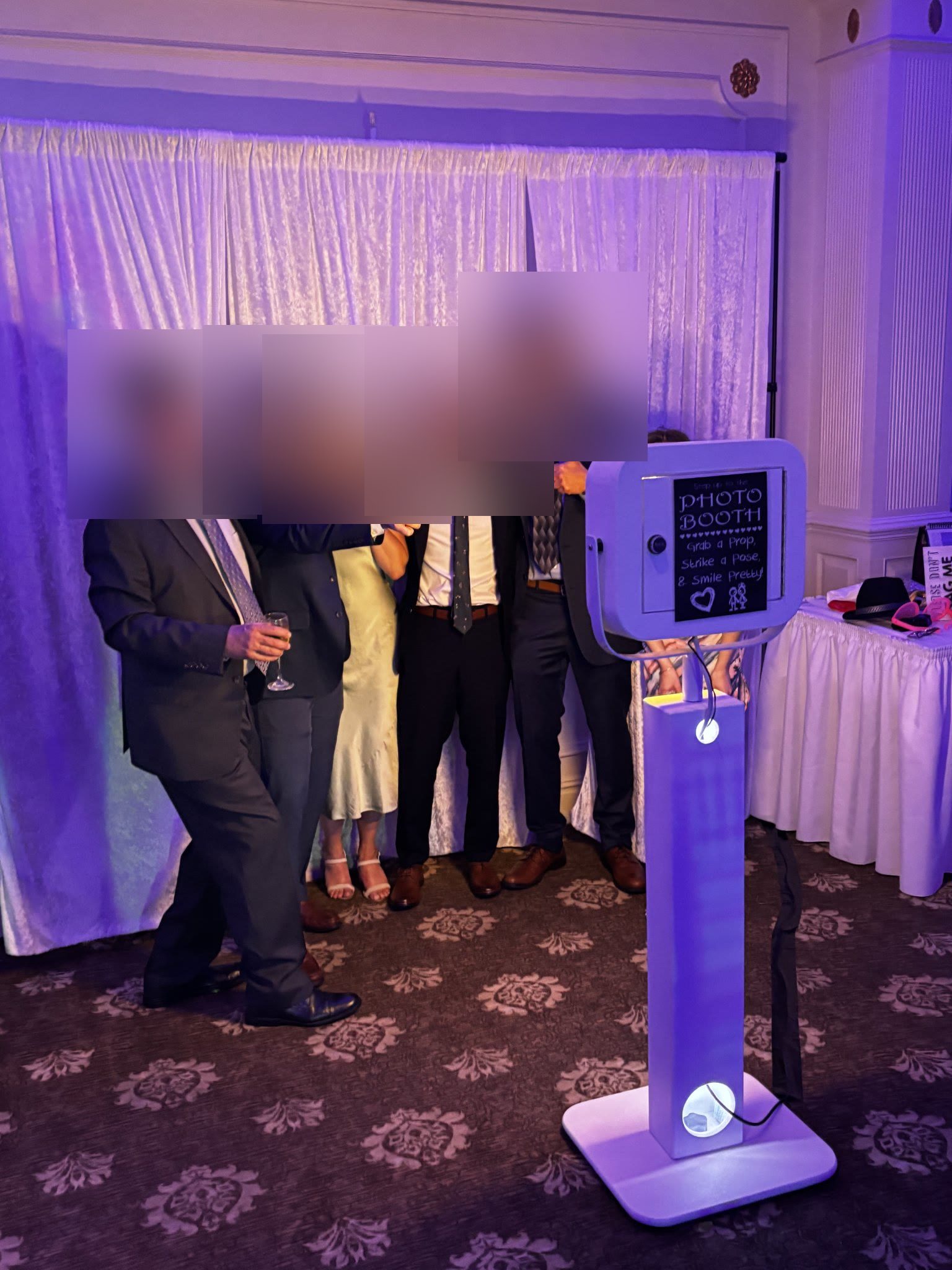 Guests posing with the selfie photo booth (faces blurred for privacy)